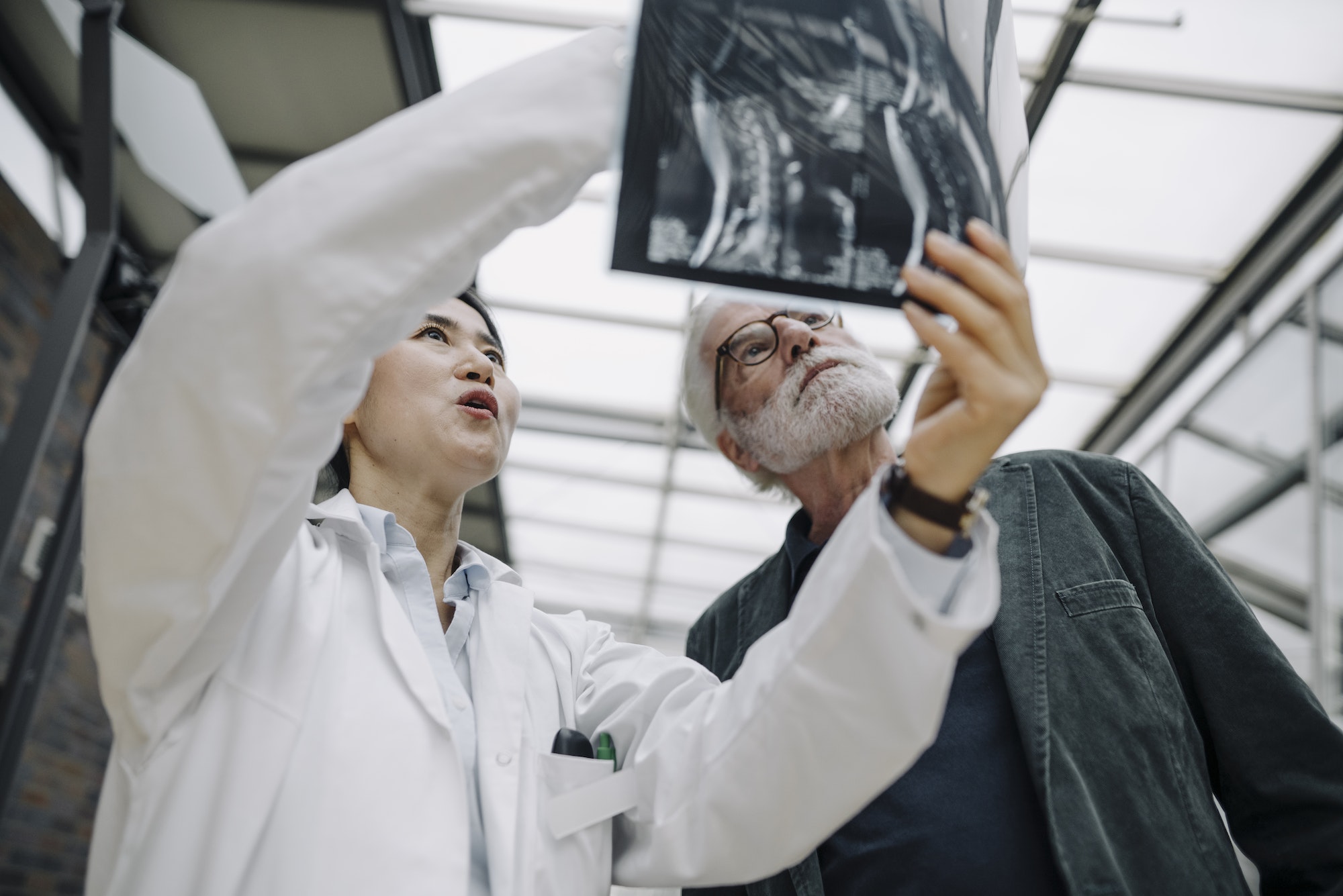 Female doctor discussing x-ray with senior patient